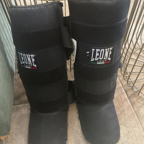 Kick boxing equipment used with gloves, wraps, shin guards, mouthguard, and bag