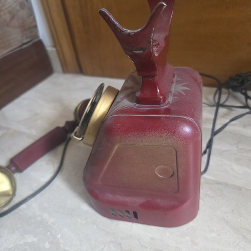 Metal telephone used, red, wired connection