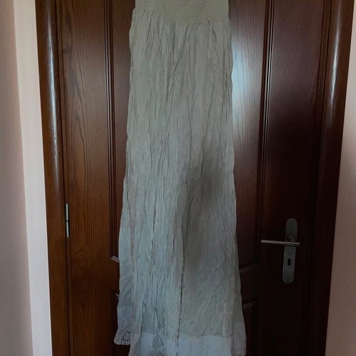 Long beige strapless dress used with honeycomb detail and neck tie