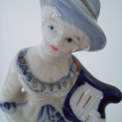 Porcelain figurine with girl musician like new