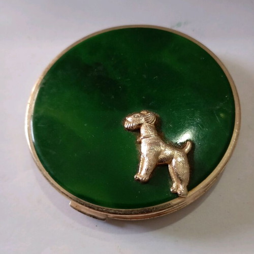Powder used in vintage metal box with dog decoration
