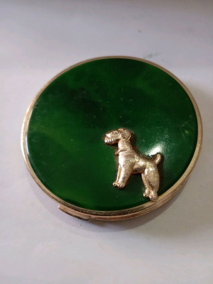Powder used in vintage metal box with dog decoration