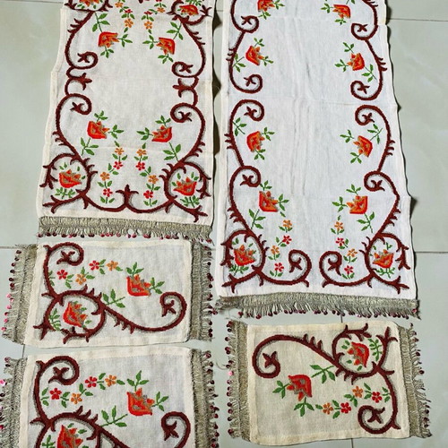 Set of embroidered handmade table linens used