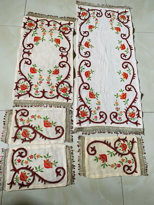 Set of embroidered handmade table linens used