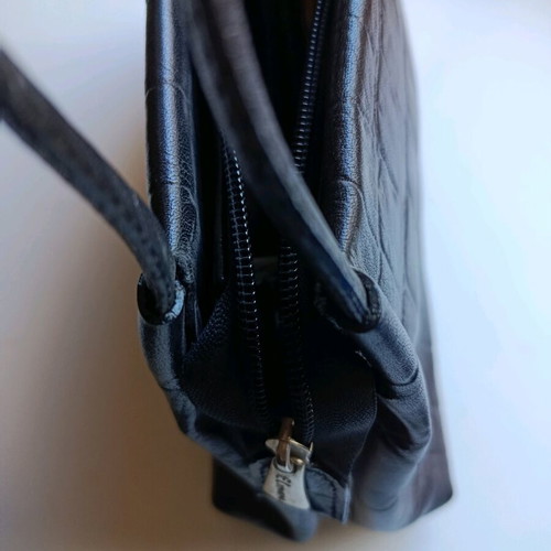 Black shoulder bag used with sturdy construction and multiple pockets