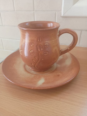 Handmade rustic ceramic coffee cup with saucer