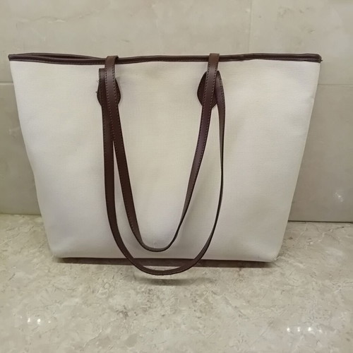 Large beige fabric shoulder bag with brown leather details