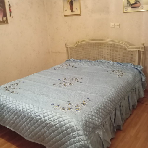 Vintage wooden double bed with wicker headboard, like new, includes slats and mattress