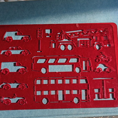 Red plastic stencil with vehicle designs