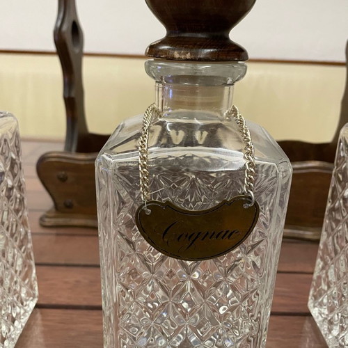 Vintage English decanters used in wooden stand for gin, cognac, whisky