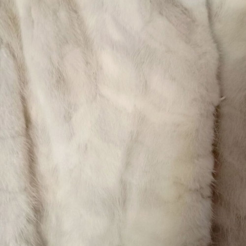 Mink fur coat in off-white and light gray, slightly worn