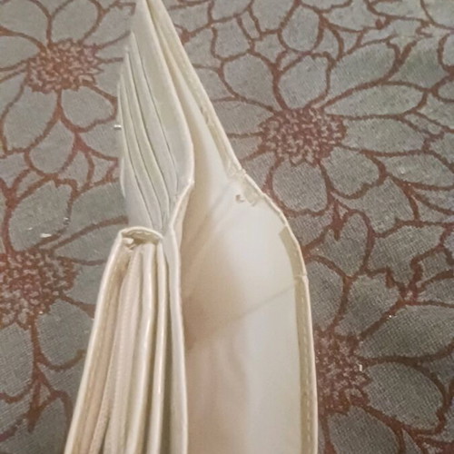 Beige wallet used with card slots and bill compartment