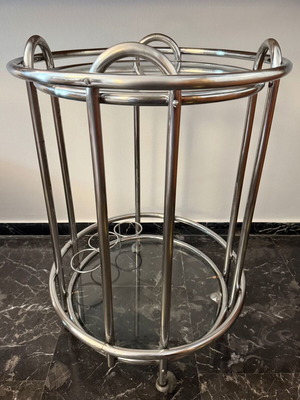 Vintage round trolley bar used with chrome tubular steel and glass shelves