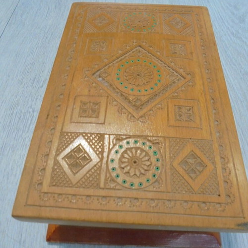 Old wooden carved box with decorative ornaments, used