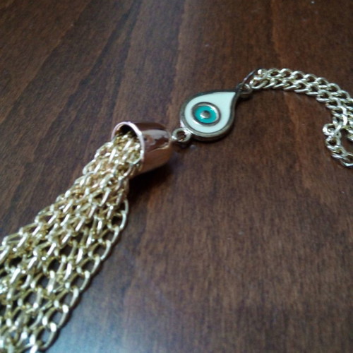 Enameled eye pendant used with gold chain and tassels