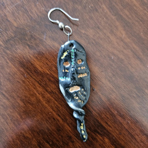 Black earring used, totem-inspired with multicolor pattern