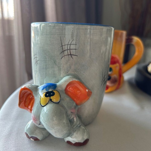 Children's ceramic mugs used, vintage with embossed elephant and lion