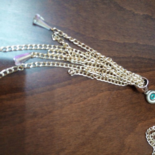 Enameled eye pendant used with gold chain and tassels