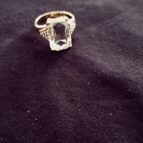 Ring made of gold steel with transparent white stone like new