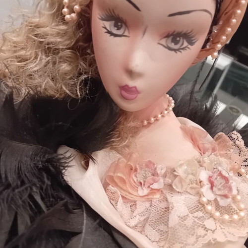 Vintage porcelain doll with feathers, handpainted, used