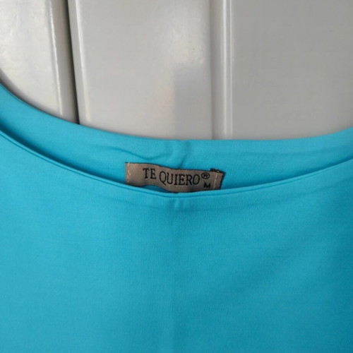 Turquoise tank top like new, fitted with strap and neckline