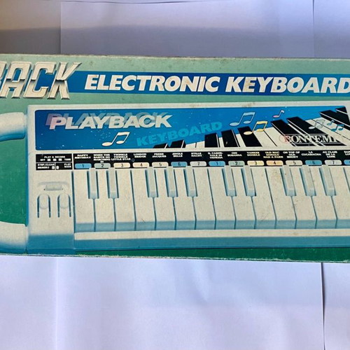 Vintage children's keyboard used with song booklet