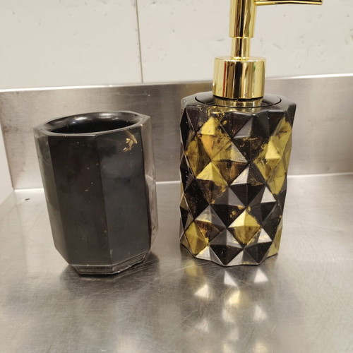 Bathroom set made of liquid glass in black with gold details