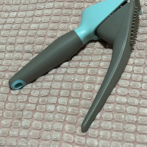 Garlic press used with ergonomic handle and easy cleaning