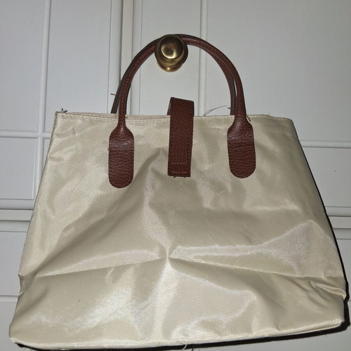Handbag like new, small beige with brown leather handles and clasp
