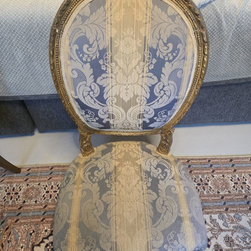 Handcrafted antique chair with fabric and carved wood
