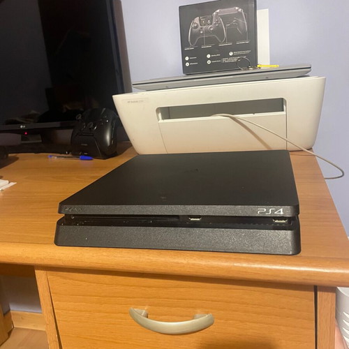 PS4 Slim console with 2 controllers and games