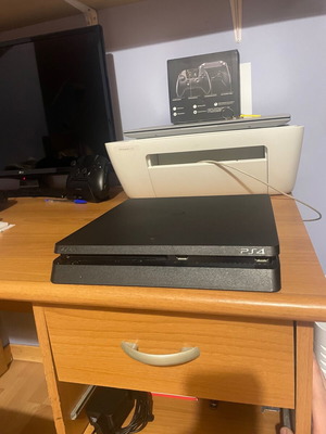 PS4 Slim console with 2 controllers and games
