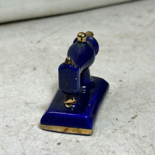 Vintage porcelain miniature sewing machine with gold details, used