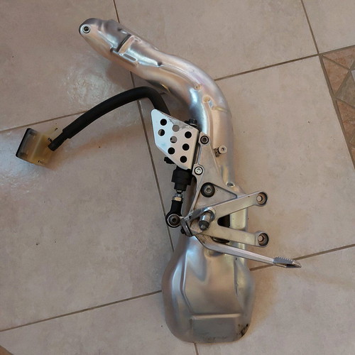 Right footrest/rear brake with brake master cylinder and exhaust guard used