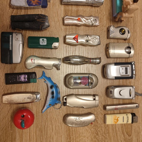Collection of 25 used vintage lighters and 3 matchboxes from hotels and restaurants