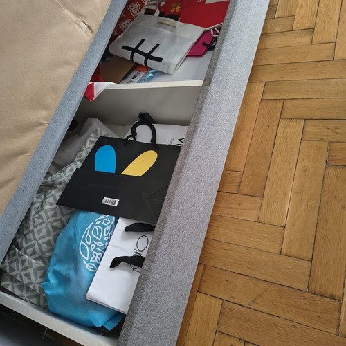 Two-seater sofa with storage and bed function