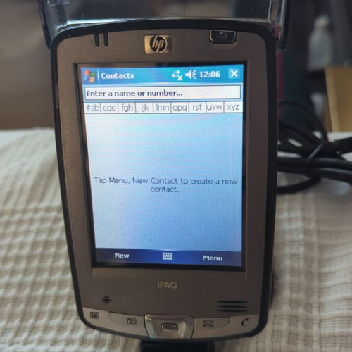 HP iPAQ HX2490b PDA used with charging dock and accessories