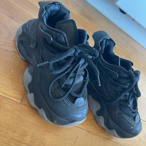 Athletic shoes used with thick sole and laces black with gray