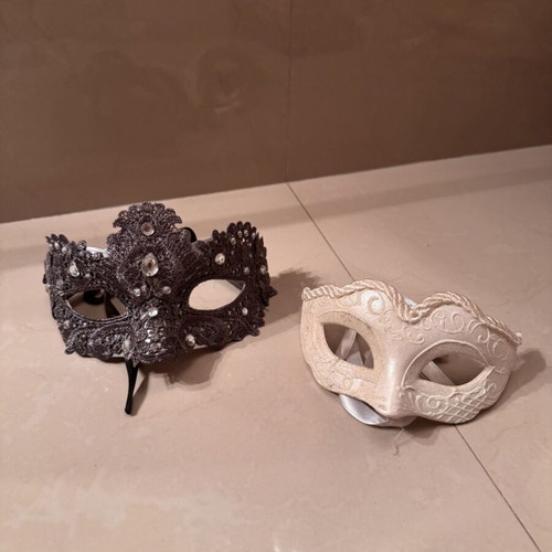 Two ornate masks like new, one gray and one white