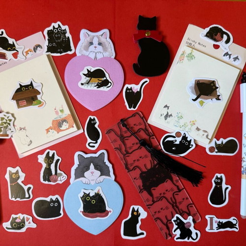 Cat-themed stationery set like new with sticky notes, pens, bookmarks, and stickers