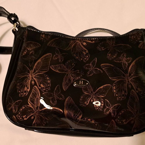 Hexagona black patent leather shoulder bag with gold butterfly pattern