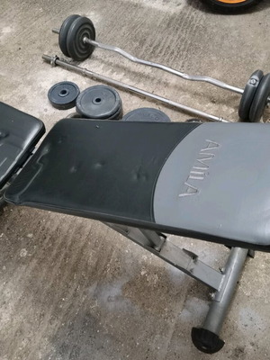 Gym equipment and weights used, set with Amila bench
