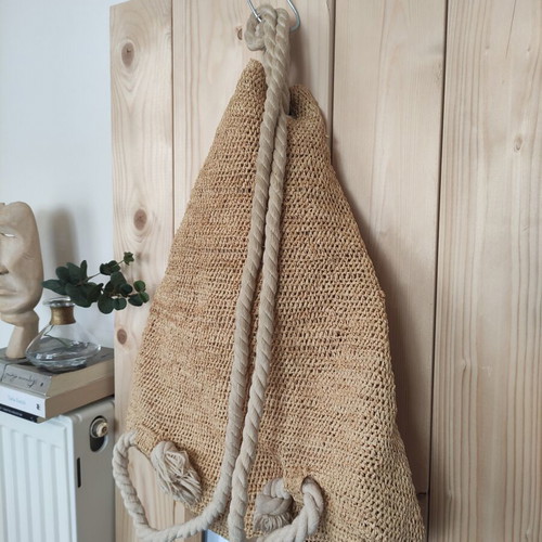 Boho straw backpack used with shells and rope straps, resort style