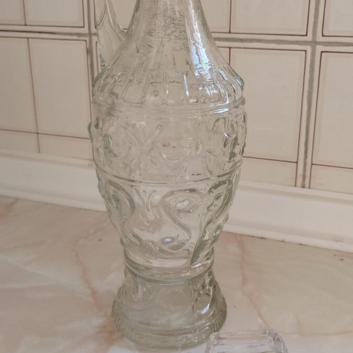 Glass decanter used with handle and beautiful pattern, unusual design