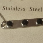 Stainless steel necklace new with plate and 3 black beads