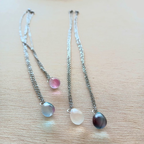 Handmade pendants from iridescent glass and steel