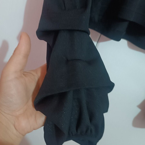 Pink Woman black crop top with long sleeves and ruffles