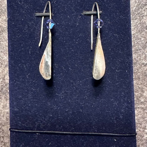 Silver earrings used with purple stones