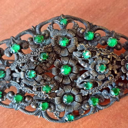 Vintage brooch used with floral filigree design and green stones
