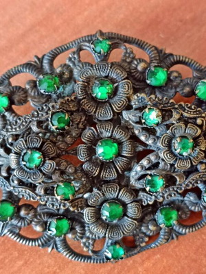 Vintage brooch used with floral filigree design and green stones